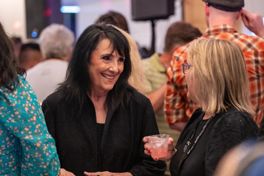 DIFF CEO Beth Wilbins chats with an attendee at the afterparty.