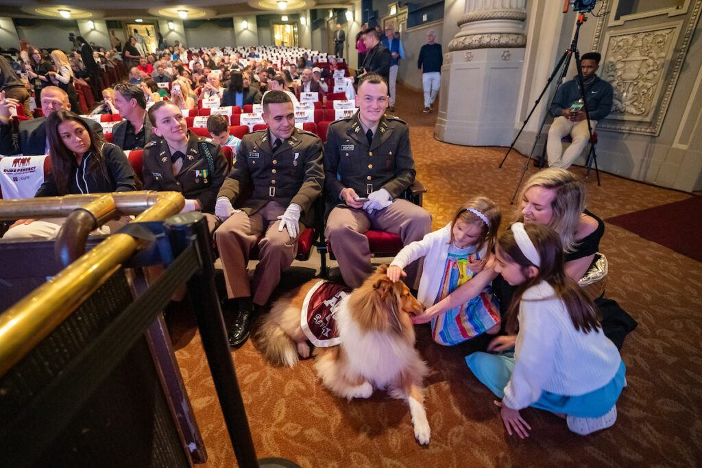 Reveille X receives pets from young fans inside the theatre prior to the screening.