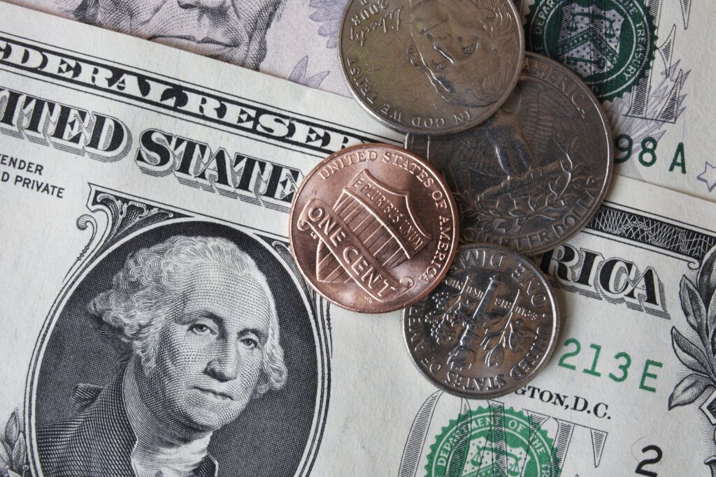 Close-up of dollar banknotes and coins