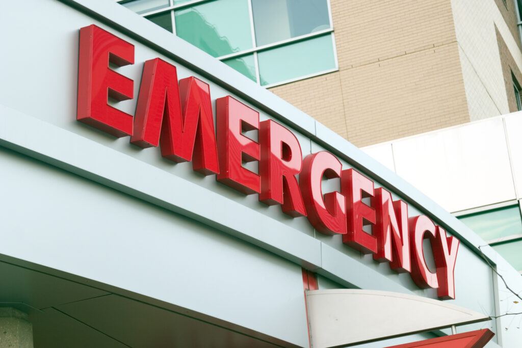 A large red emergency sign on a hospital entrance.