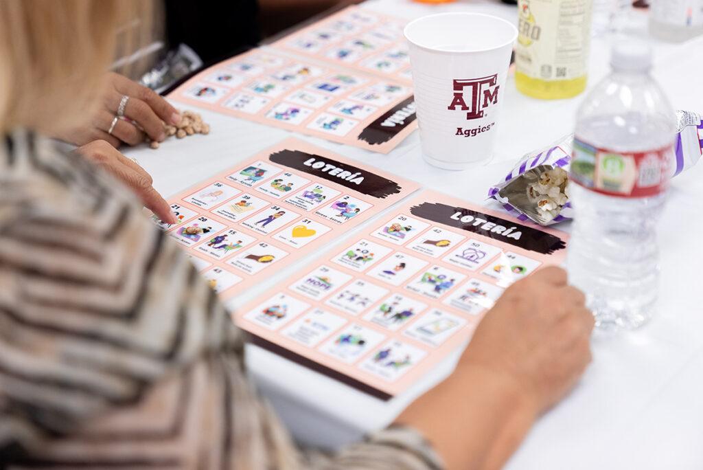a participant at the Mental Health Fair playing a Loteria game