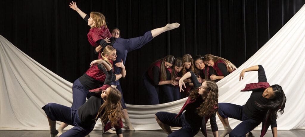 Dancers perform on stage in a rehearsal for an upcoming production from the Texas A&M University School of Performance, Visualization and Fine Arts.