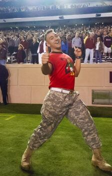 A photo of a cadet on Kyle Field during a Midnight Yell Practice at Texas A&M University.