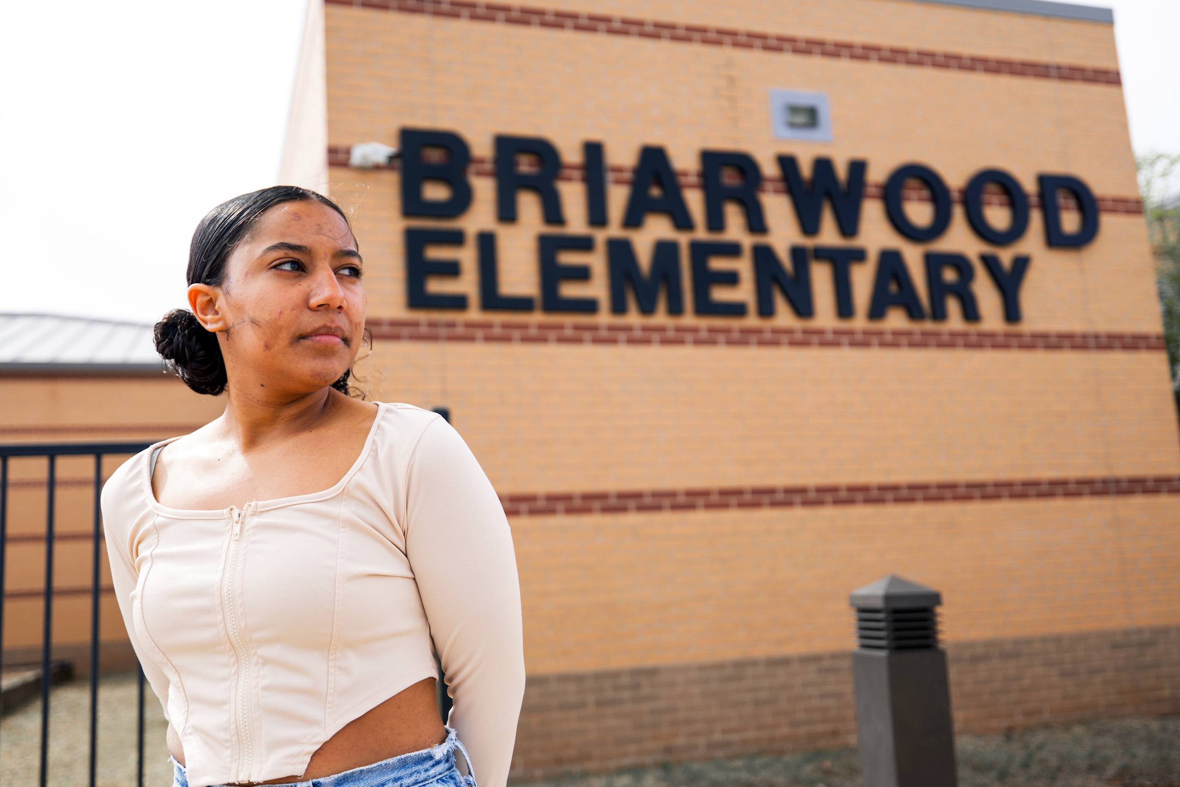 Vargyas, pictured on a sunny afternoon on March 30, 2024, outside her former elementary school, which was rebuilt after being destroyed in the 2013 tornado.