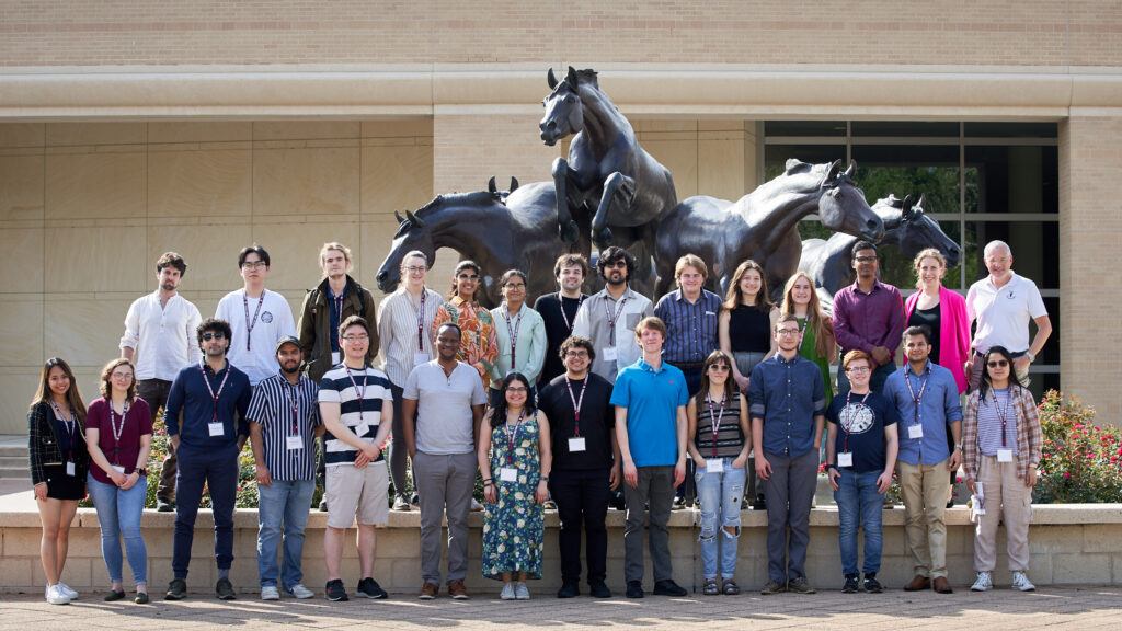 A group photos of selected participants in the Lindeau Nobel Laureate Meetings in front of the horse statue at the George H.W. Bush Presidential Library and Museum.
