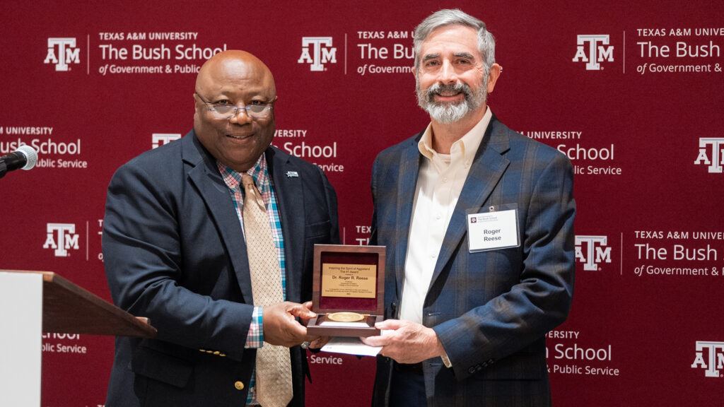 Dr. Roger R. Reese receives an award from Dr. Frank B. Ashley III.
