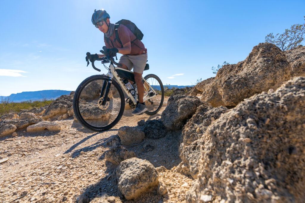 A mountain bike rider on a trail in the desert.