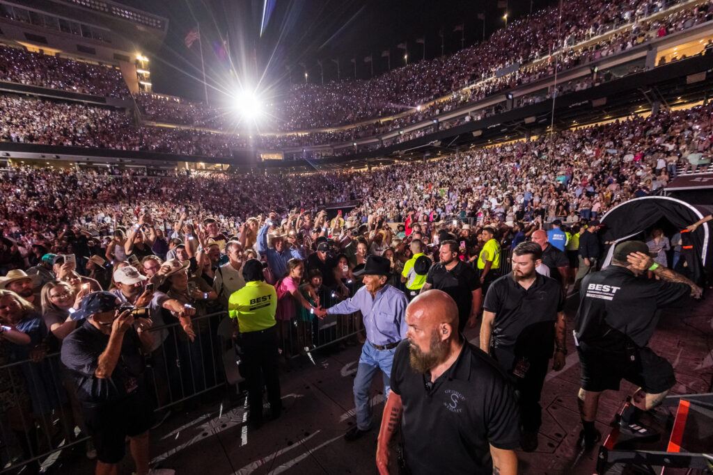 Fans cheer as George Strait enters Kyle Field for a concert.