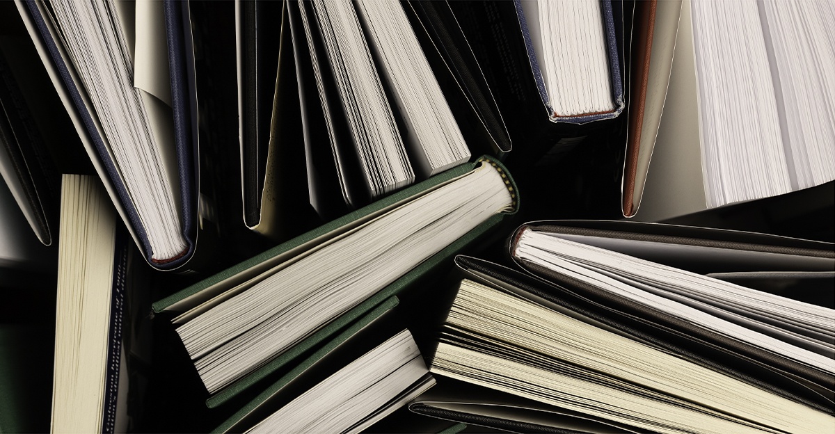 a photo from above shows several partially-opened books standing up on a table