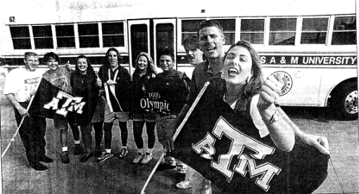 A group of bus drivers standing beside an A&M bus preparing for the Olympics in Atlanta