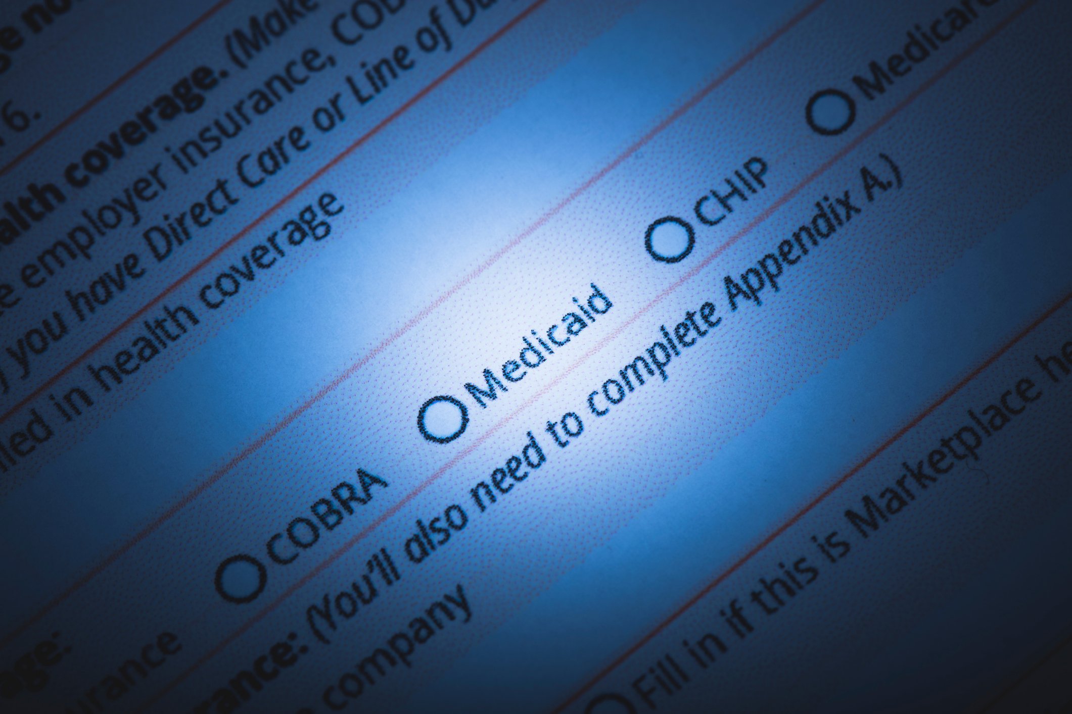 a health insurance enrollment form with a spotlight over the word Medicaid