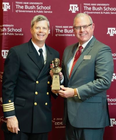 A photo of two men during an awards presentation.
