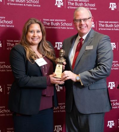 A photo of a man and woman during an award presentation.