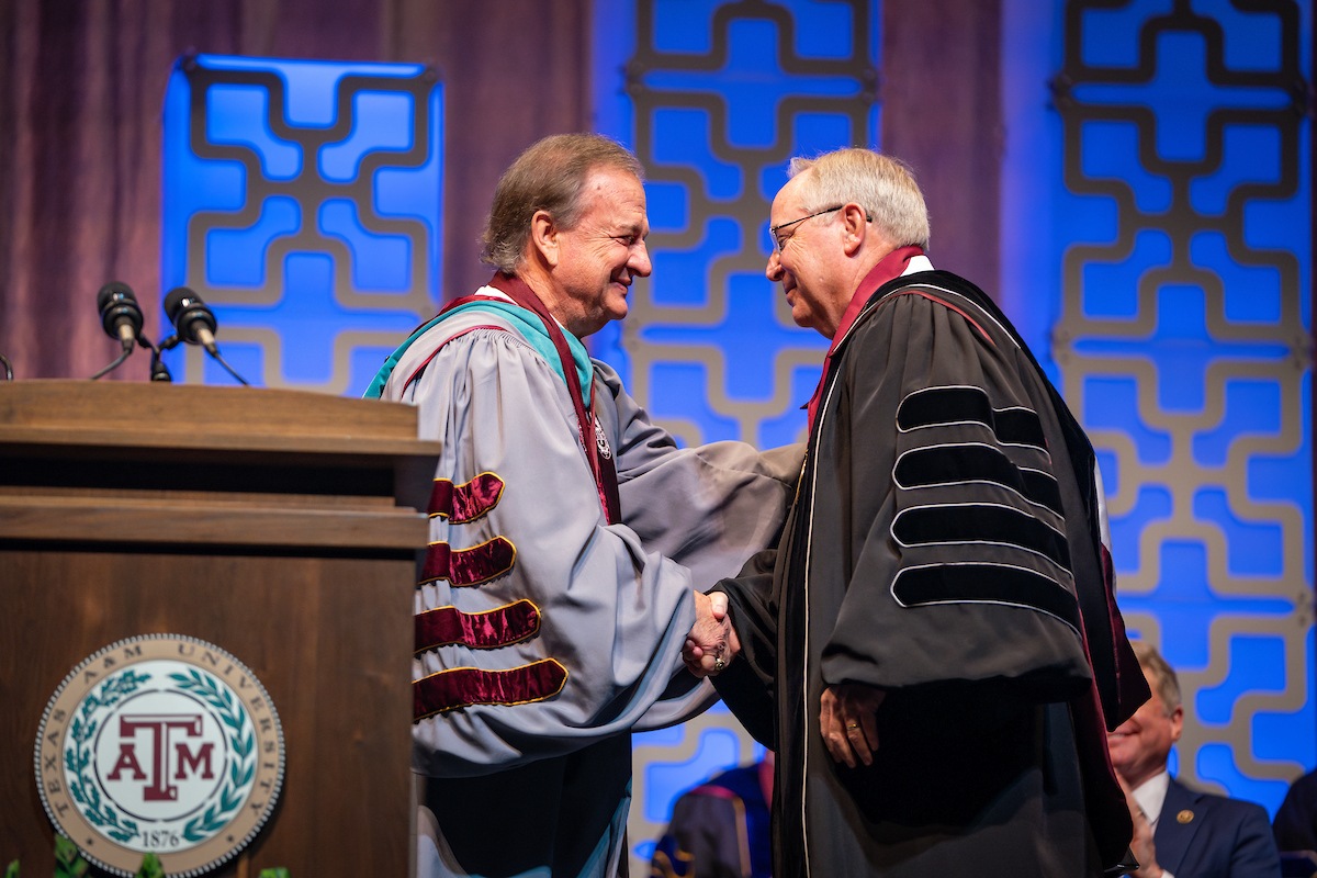 Chancellor John Sharp shaking hands with President Mark Welsh