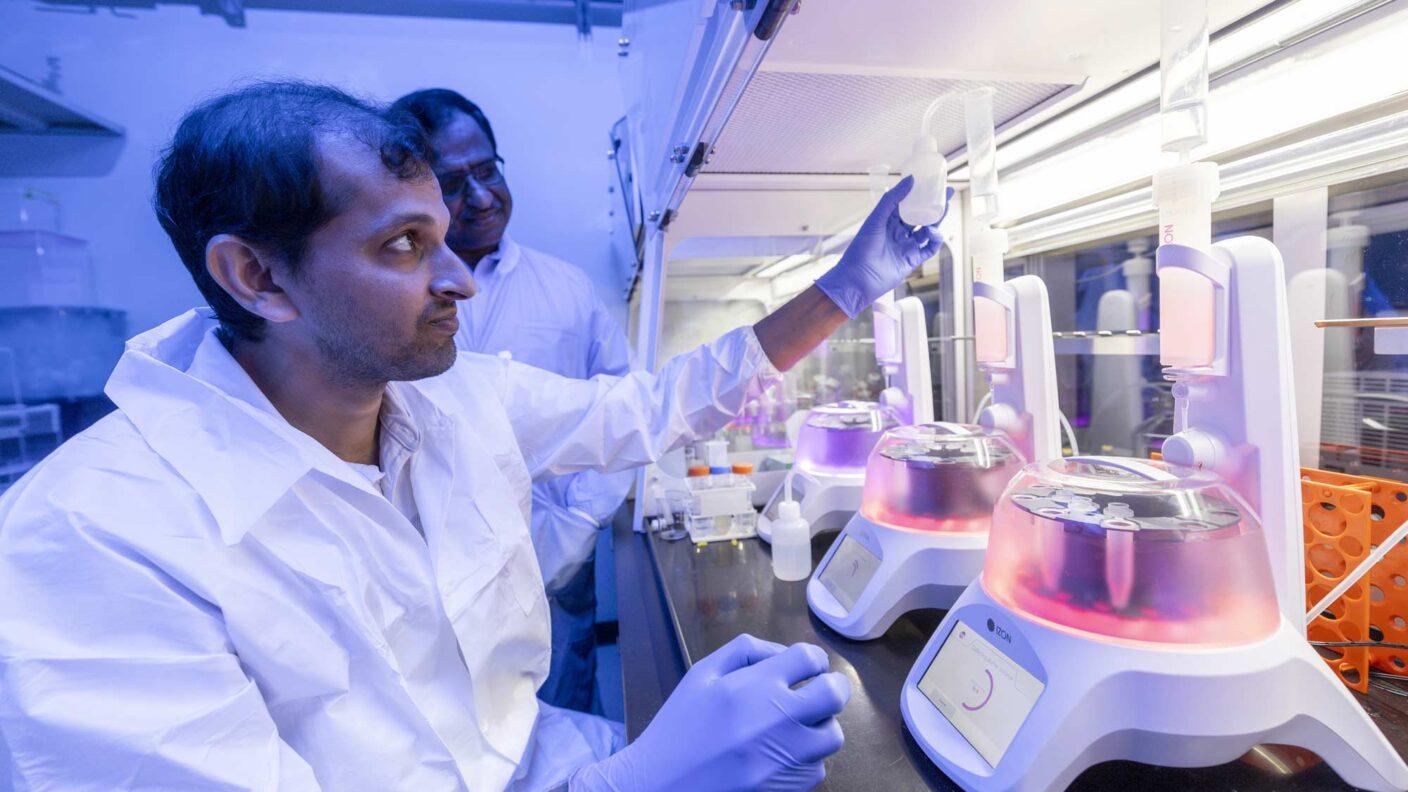 A photo of researchers in a lab with scientific equipment.