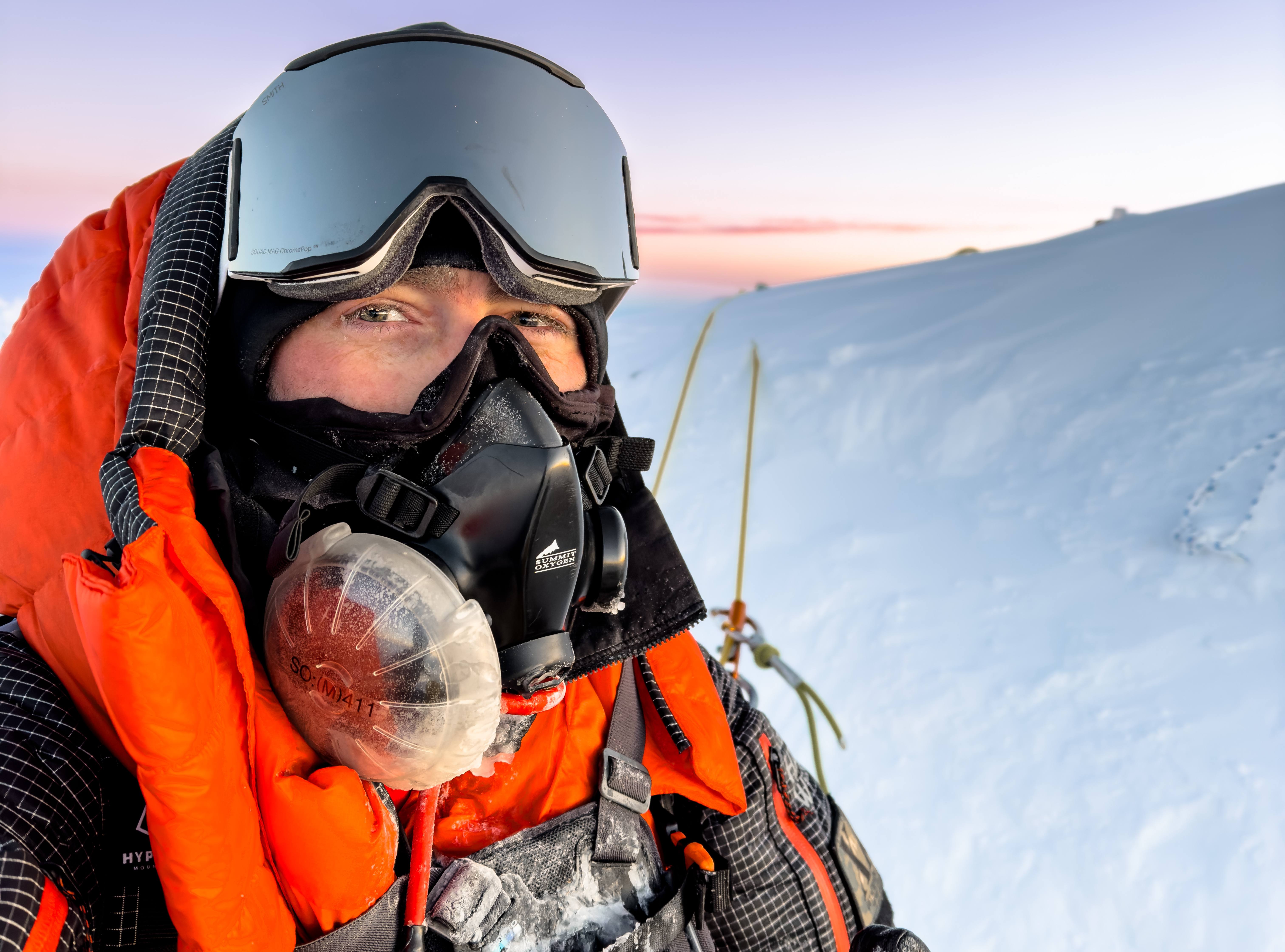 A selfie photo of a mountain climber on top of Mount Everest