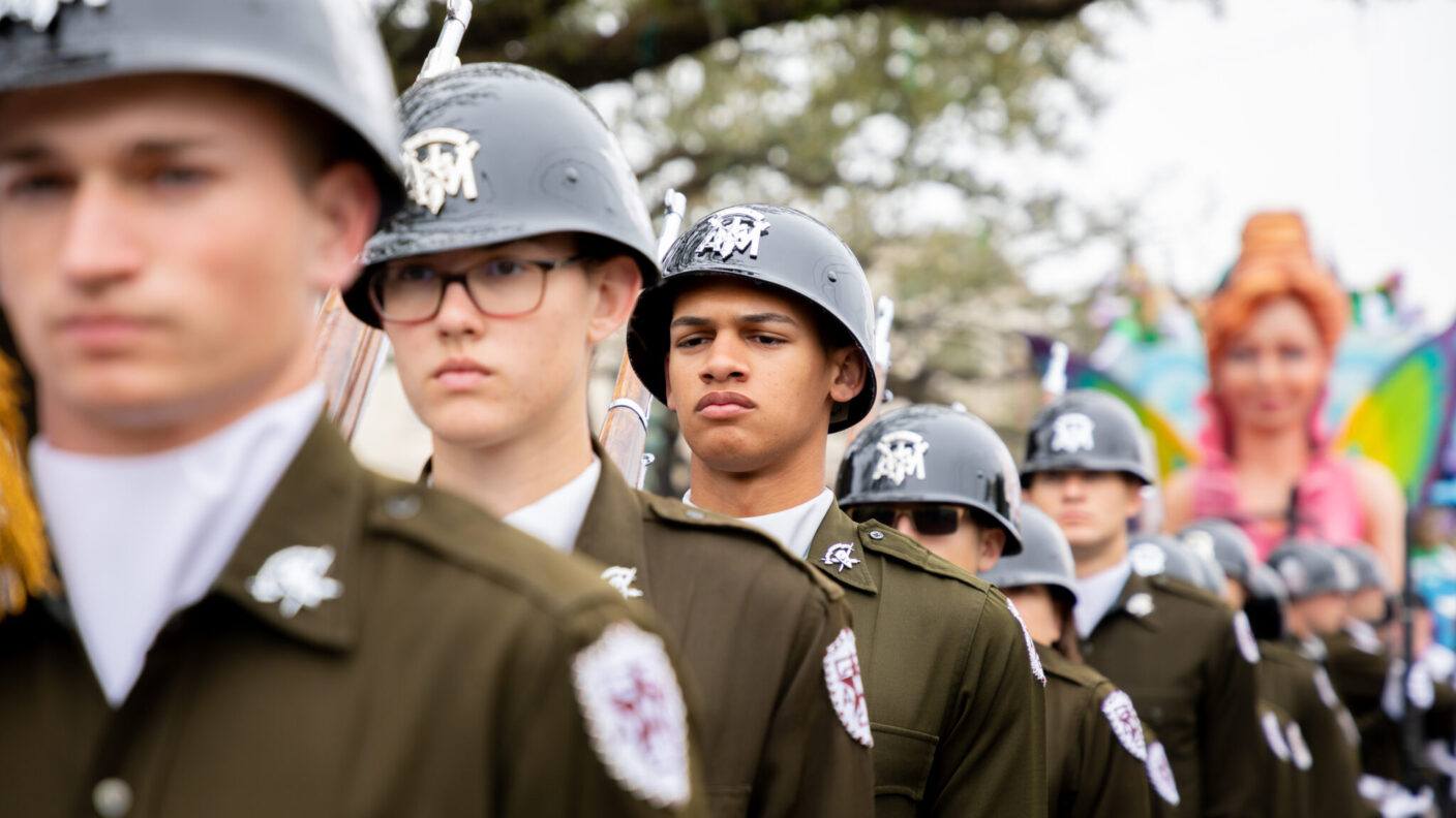 Members of the Fish Drill Team from the Texas A&M University Corps of Cadets in a marching formation while participating in a parade.