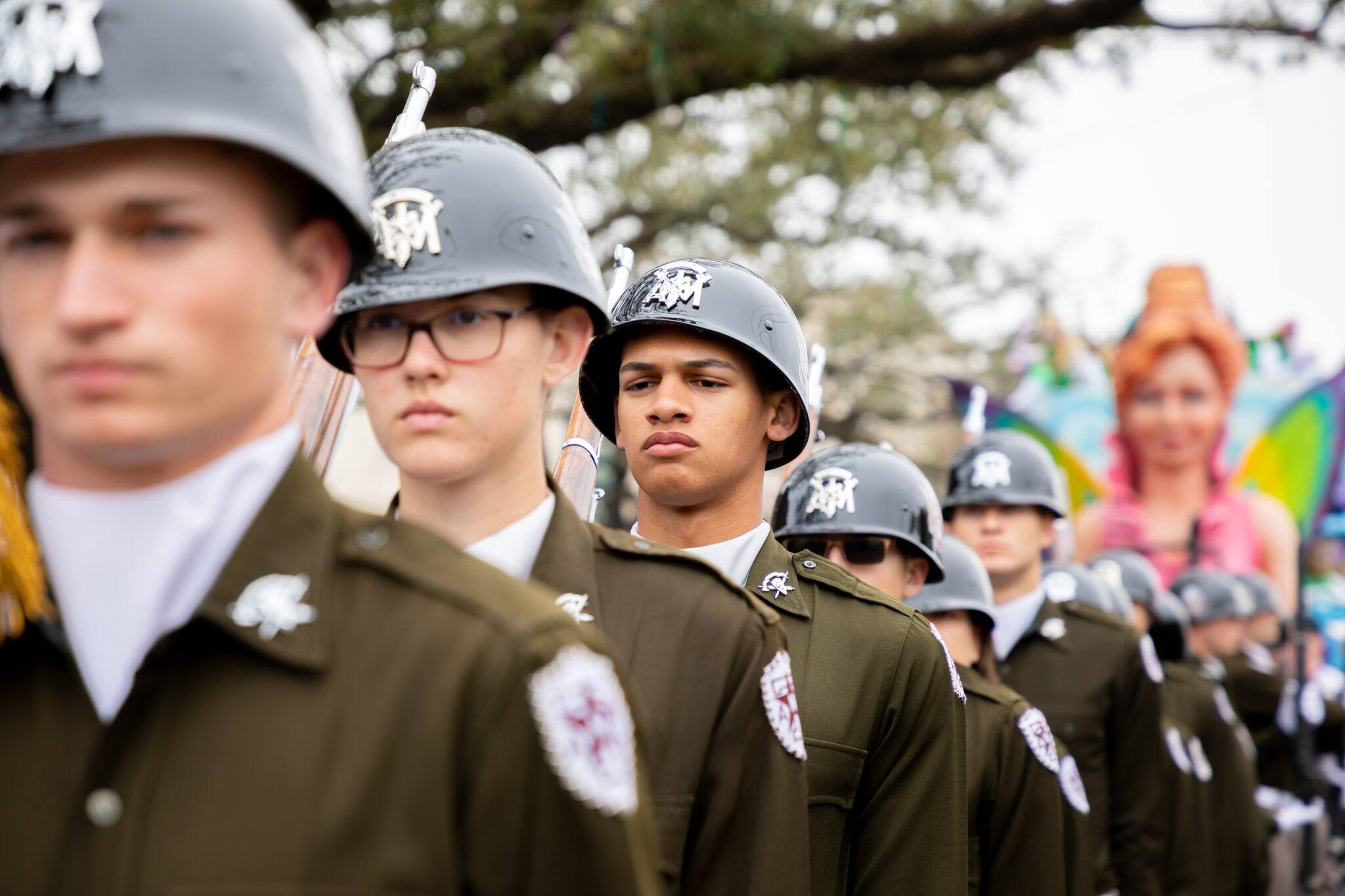 Members of the Fish Drill Team from the Texas A&M University Corps of Cadets in a marching formation while participating in a parade.