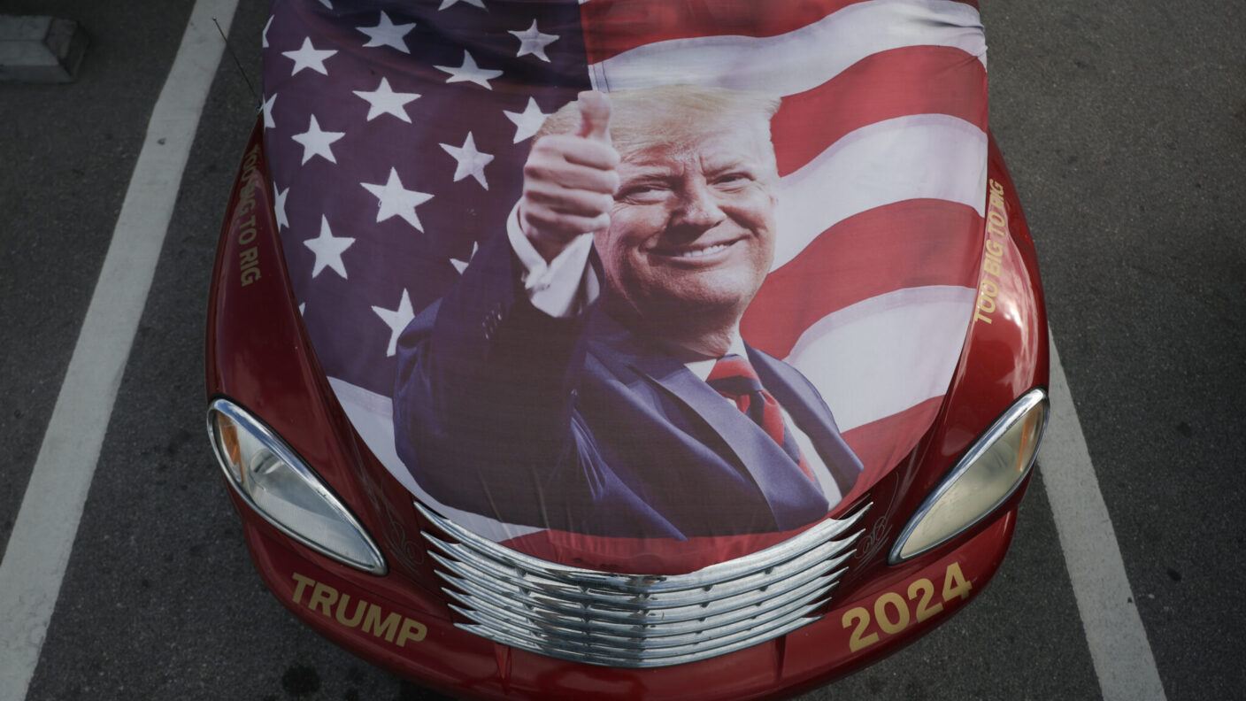 A flag of President-elect Donald Trump sits on the hood of a car near his Mar-a-Lago resort on December 12, 2024, in Palm Beach, Florida.