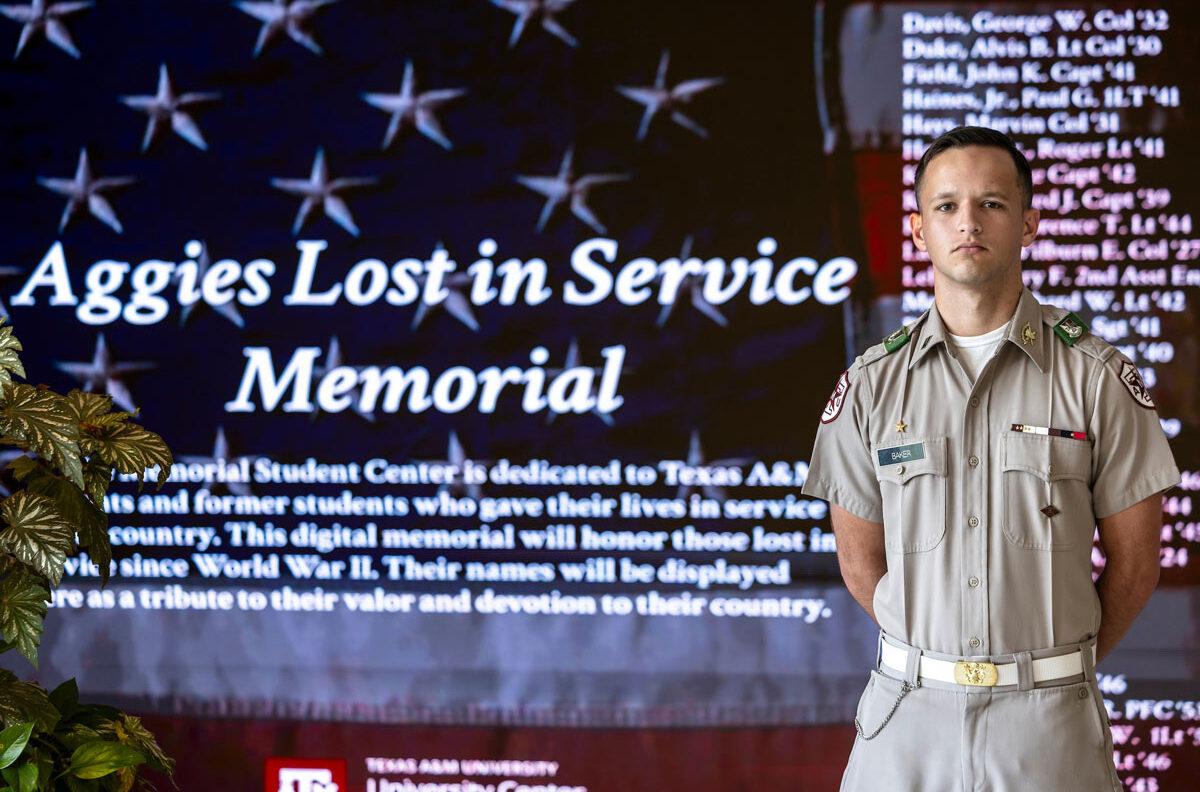 Cadet Jackson Baker stands in front of the Aggies Lost In Service memorial in the MSC