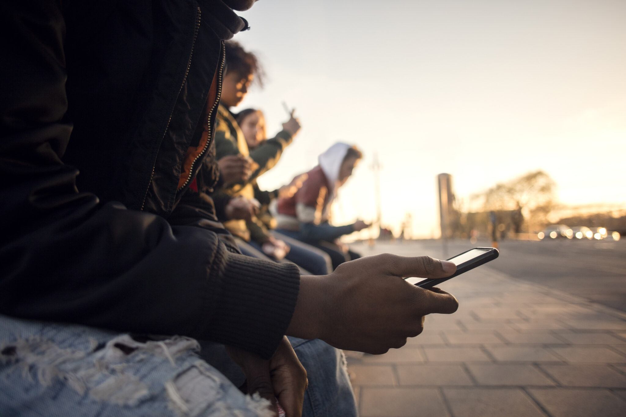 a group of teenagers holding cell phones