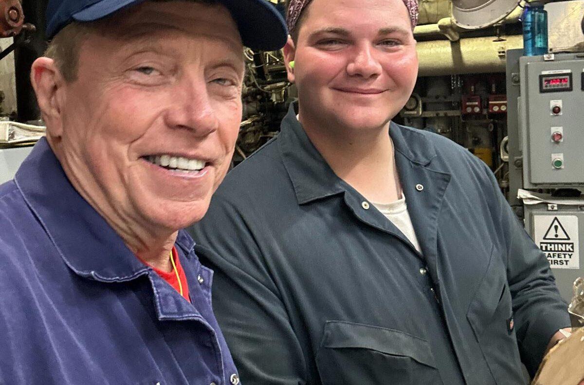 Mike Fossum smiling with a student at Texas A&M Galveston