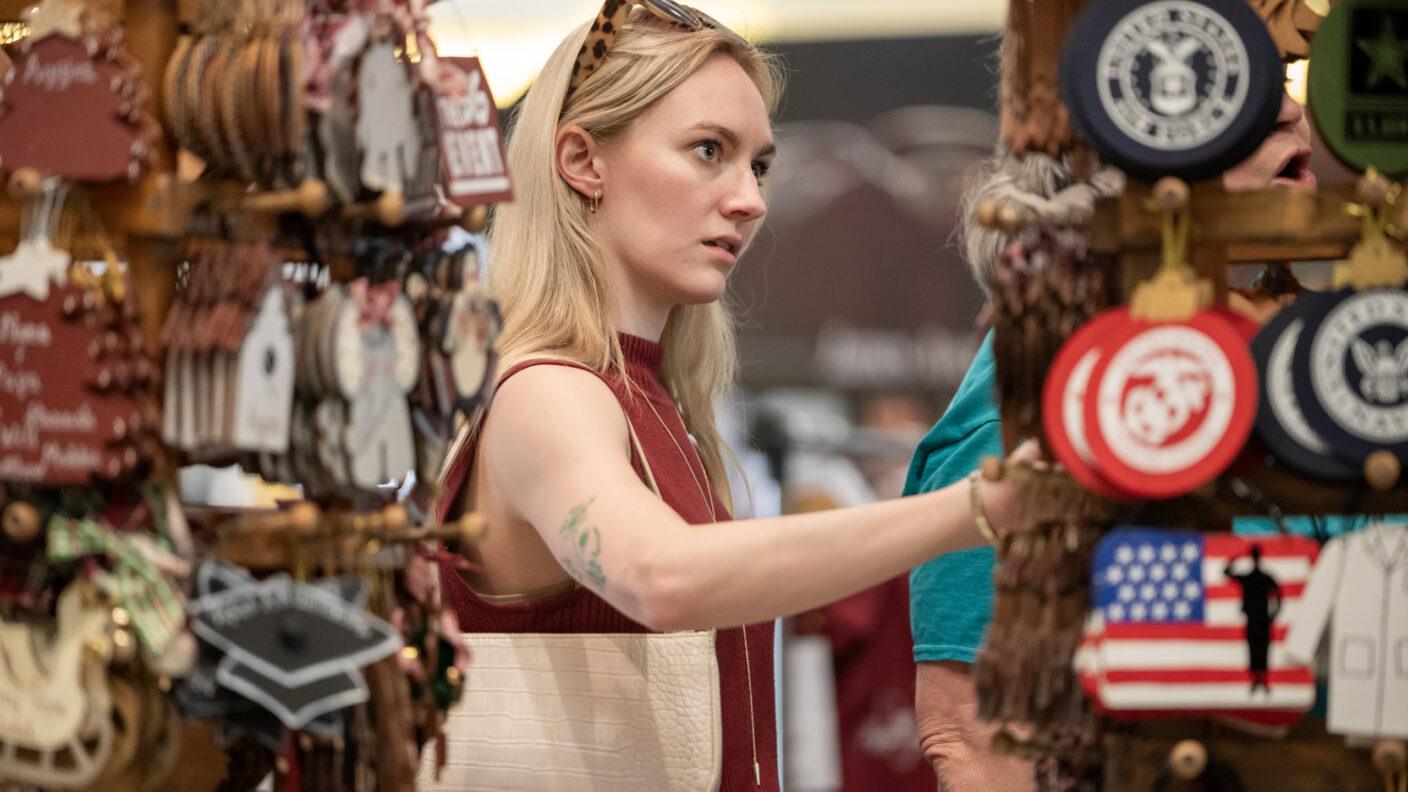 A photo of a woman looking through a display of merchandise during the Aggie Moms' Boutique.