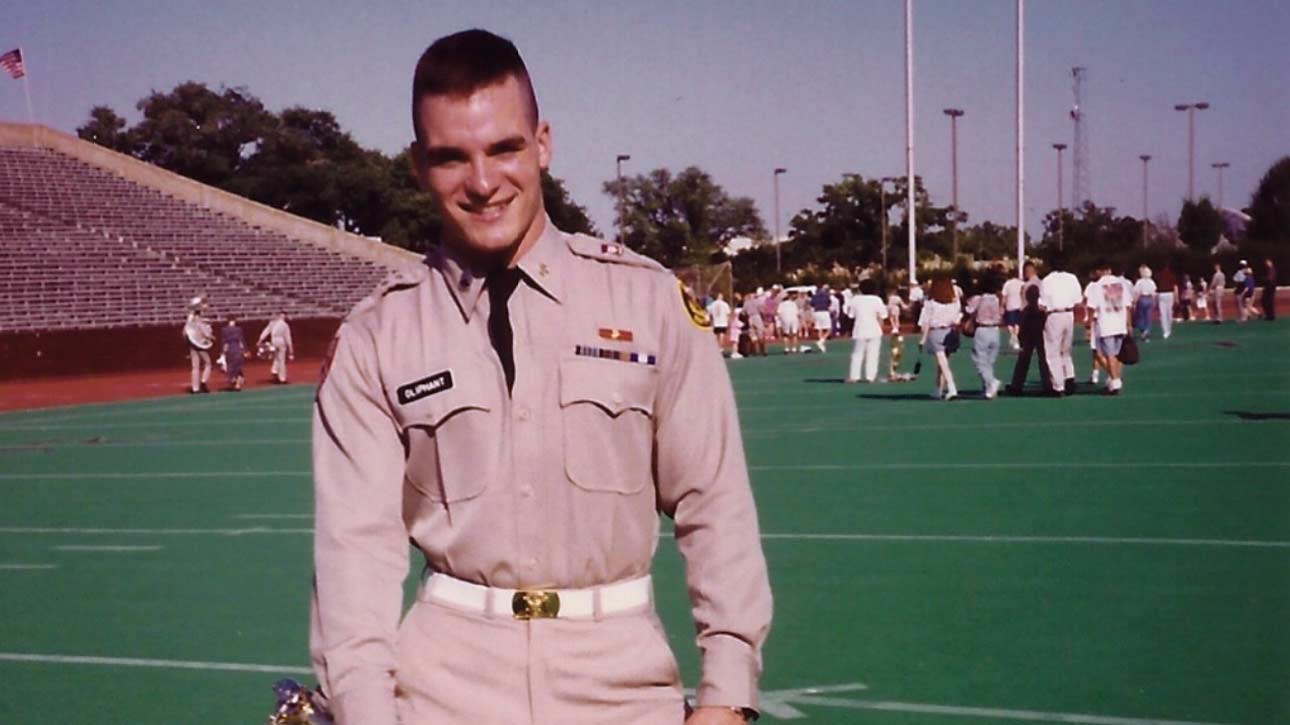Eric Oliphant in his Aggie Band uniform on a football field.