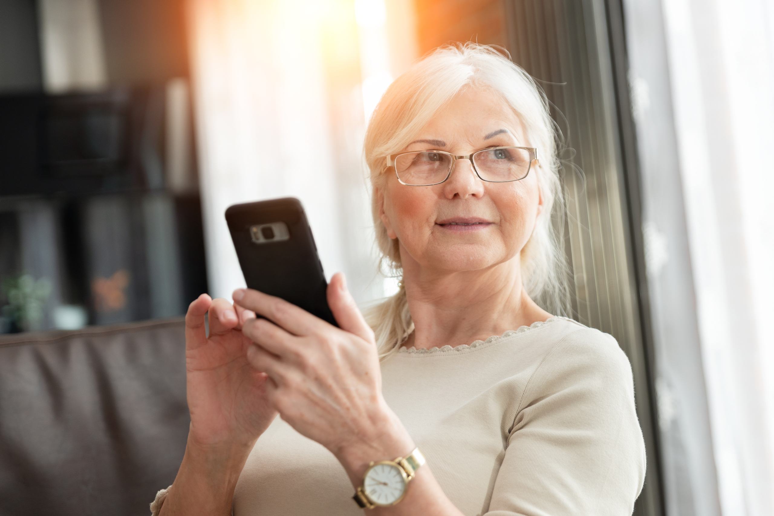 Portrait of elegant senior woman with smartphone