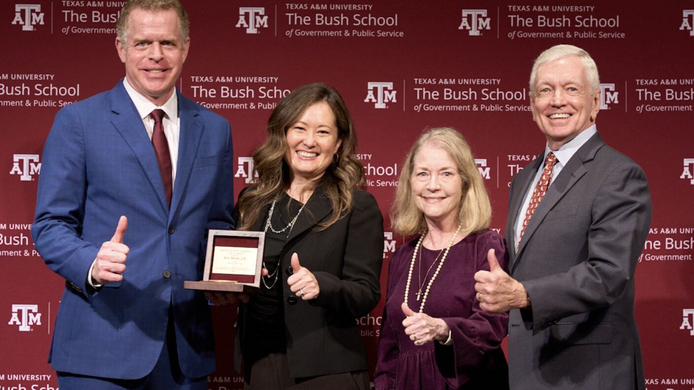A photo of four people at an awards event.