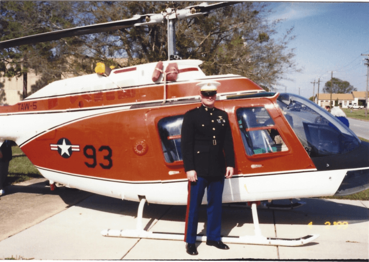 Eric Oliphant in front of a Coast Guard helicopter