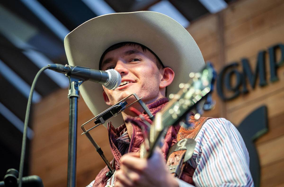 Garrett Talamantes simultaneously plays the harmonica, sings and plays the guitar.