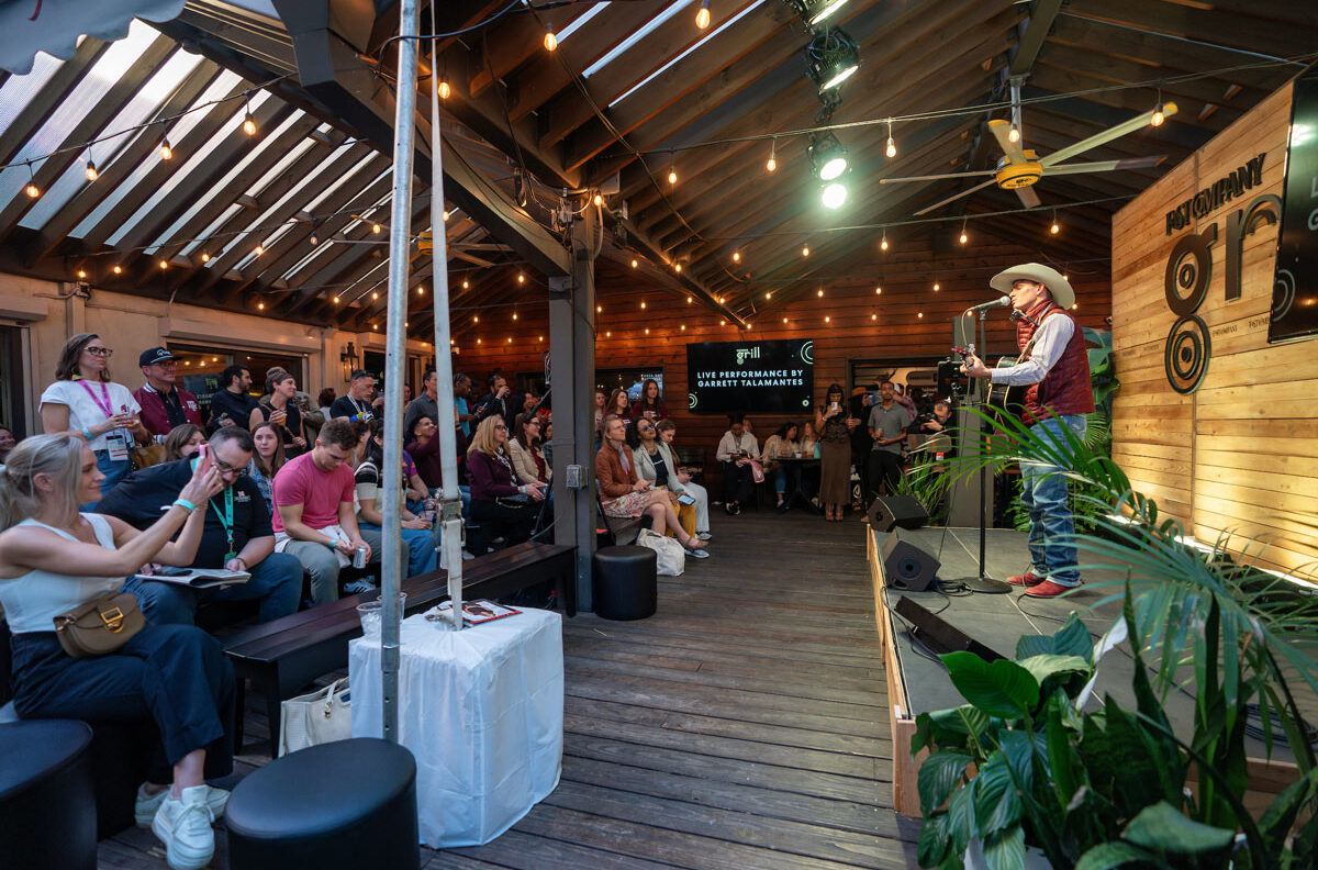View of the Garrett Talamantes singing to the crowd at the Fast Company Grill