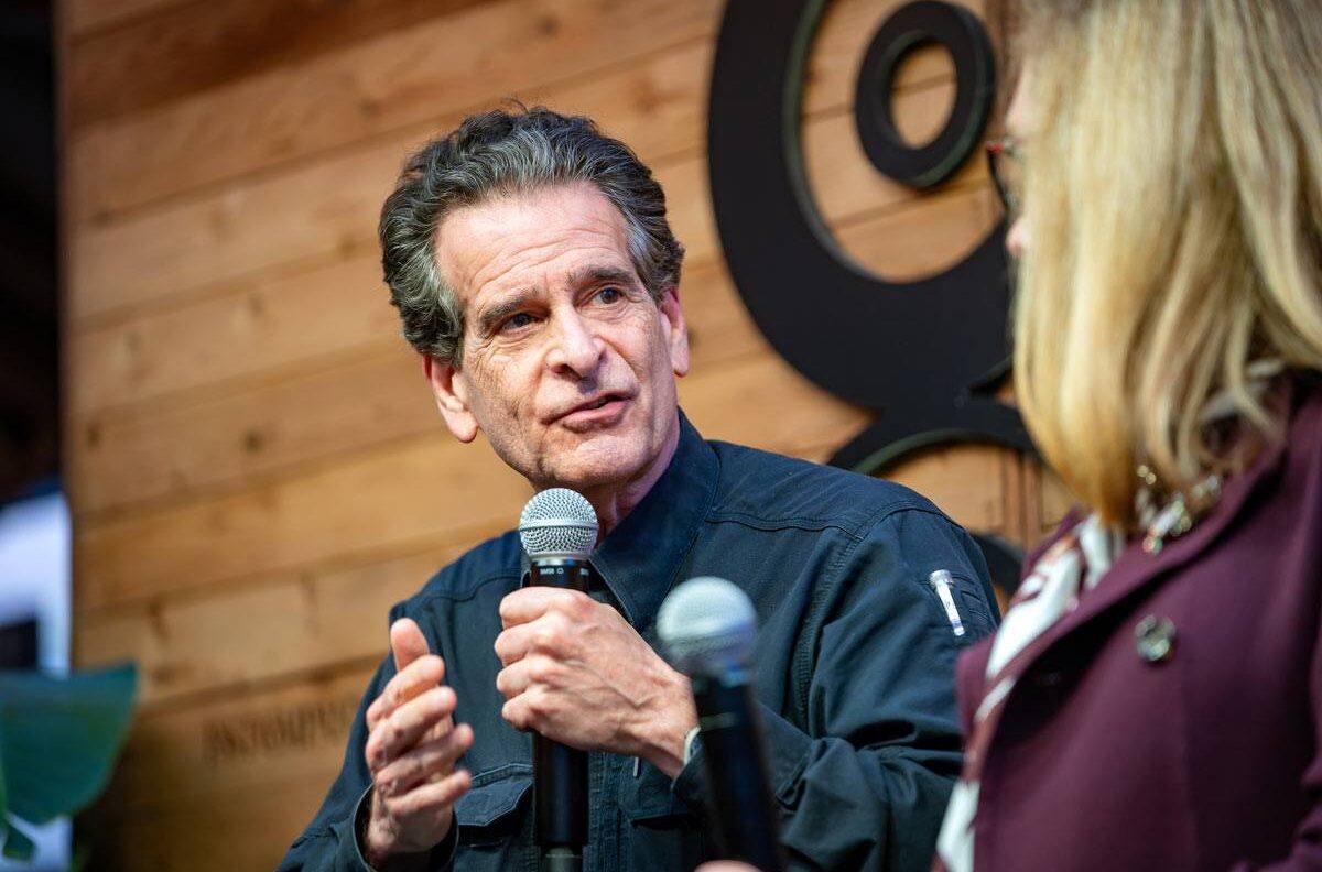 Dean Kamen speaking into a handheld microphone as part of the SXSW leadership panel