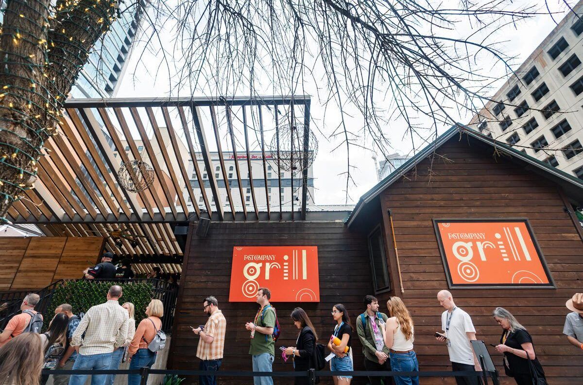 A line of people waiting to go inside the Fast Company Grill