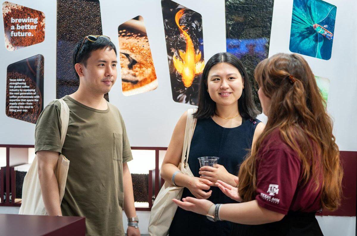 SXSW attendees talk to a Texas A&M representative