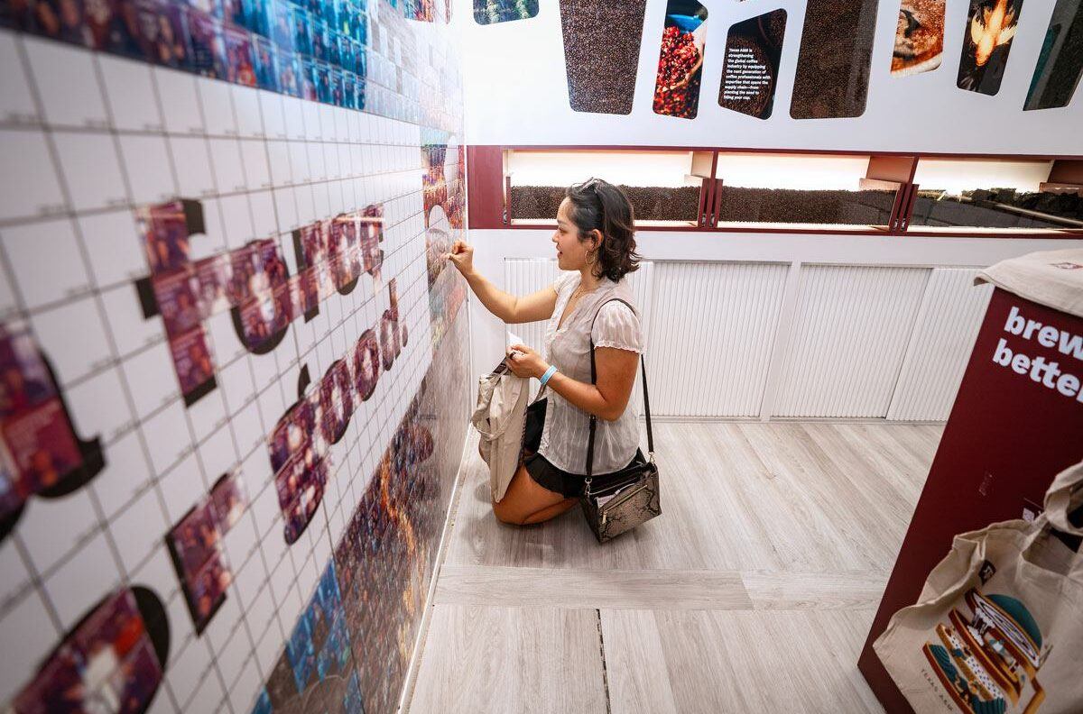 A SXSW attendee adds their selfie to the "a force for good" mural