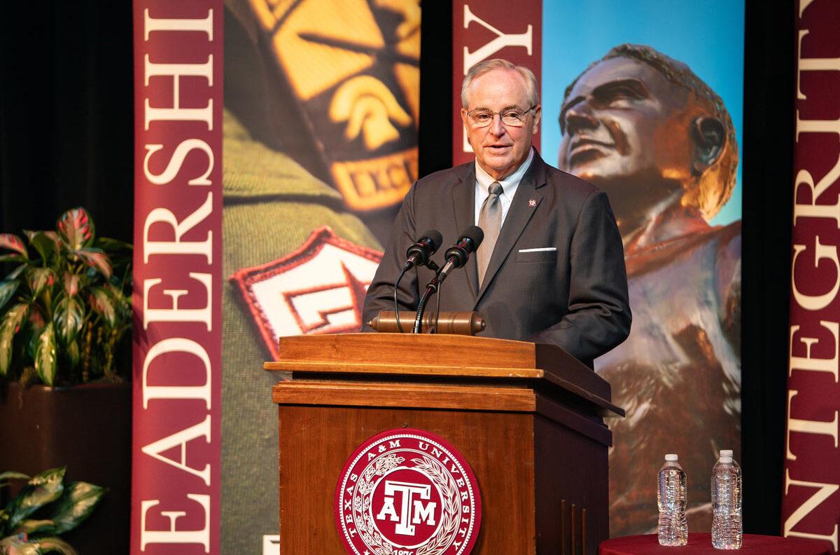 President Welsh speaking at a podium at the 2025 Excellence Awards Ceremony