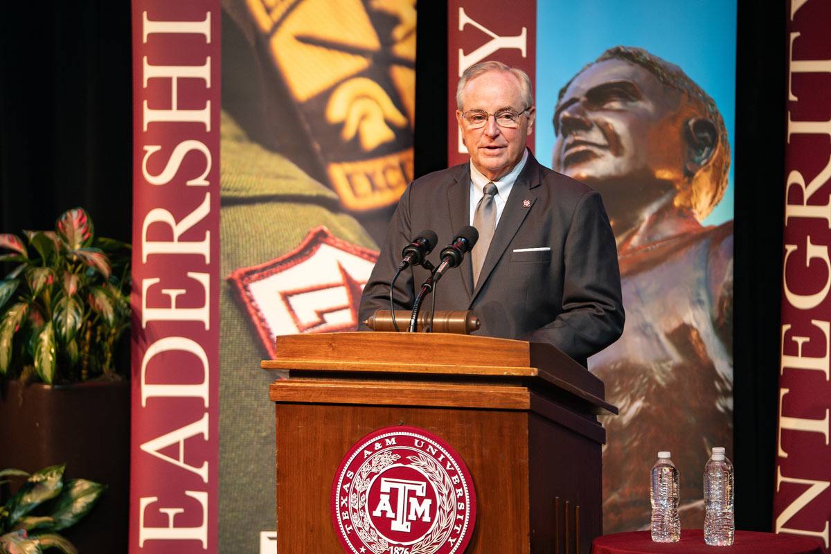 President Welsh speaking at a podium at the 2025 Excellence Awards Ceremony