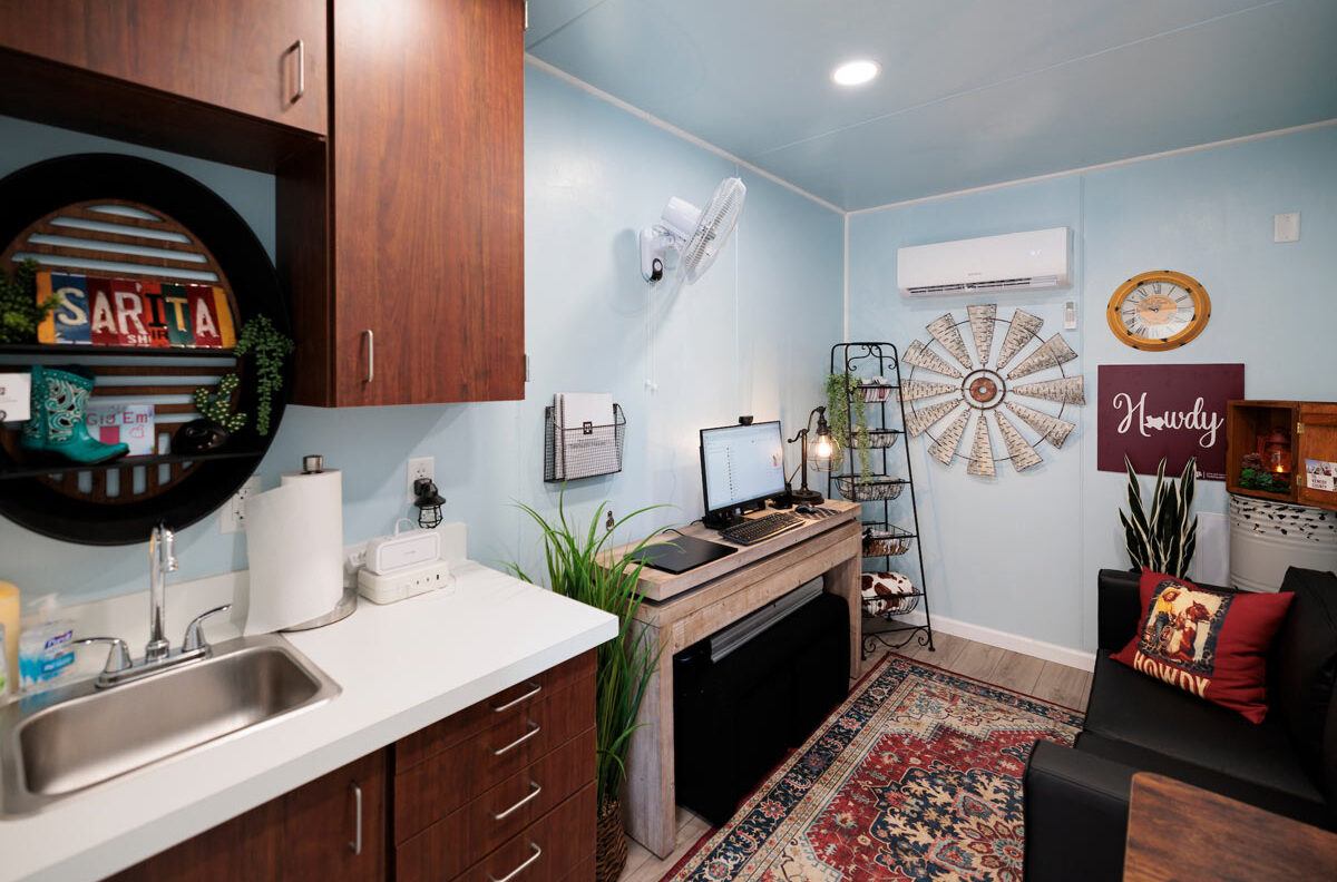 A comfortable chair and a desk set up to provide telehealth services