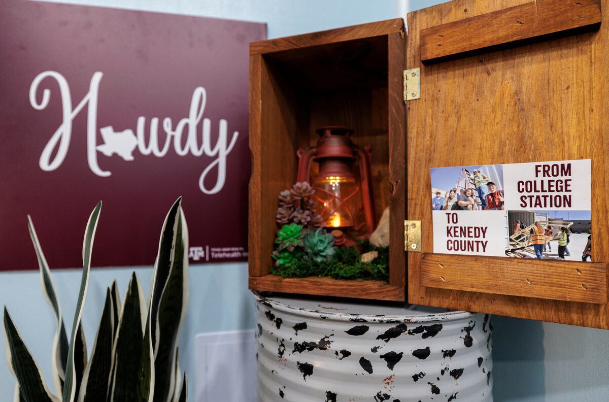Decorative cabinet with a small poster showing how the Kenedy County Medical Clinic went from College Station to Kenedy County