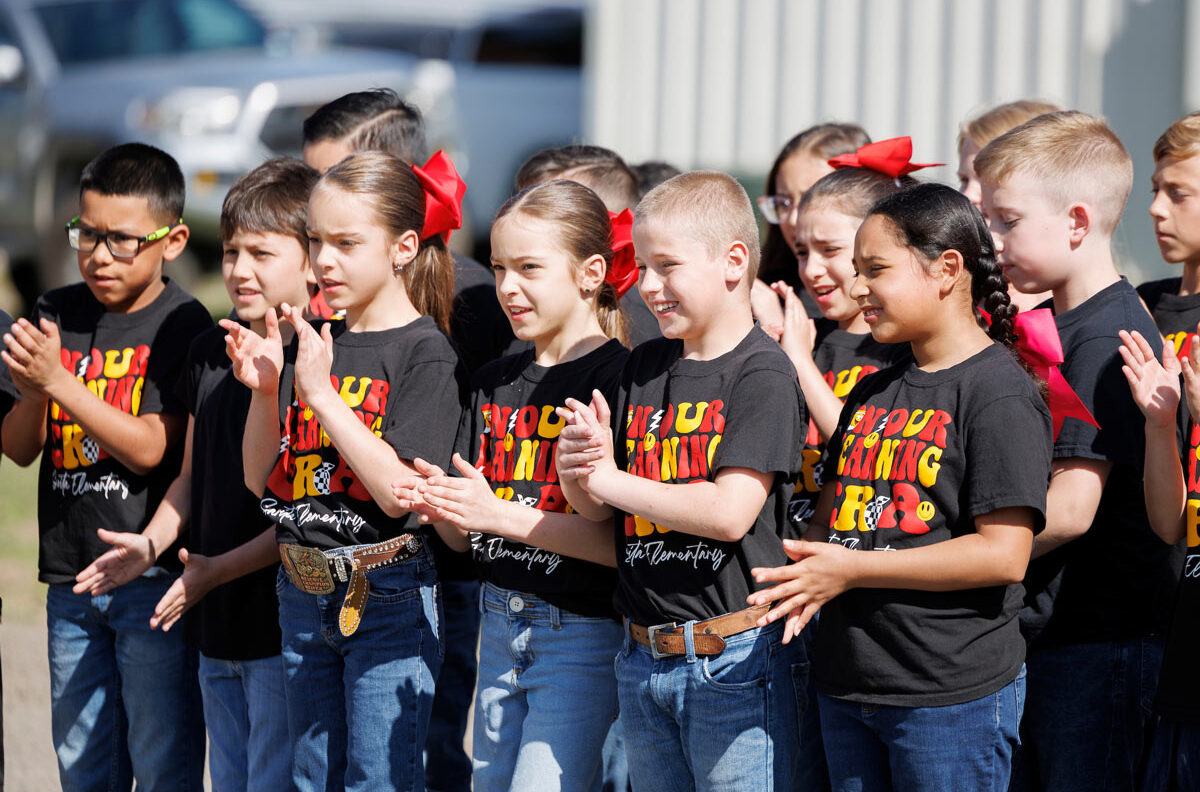 A group of elementary students clap during the Kenedy County Medical Clinic ribbon cutting.