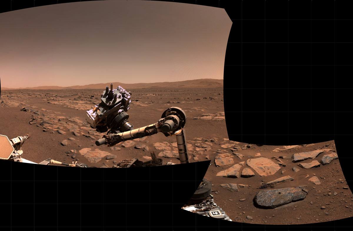 A mosaic of two pictures showing the rover arm after scanning and sampling one of the rocks discussed in the paper.