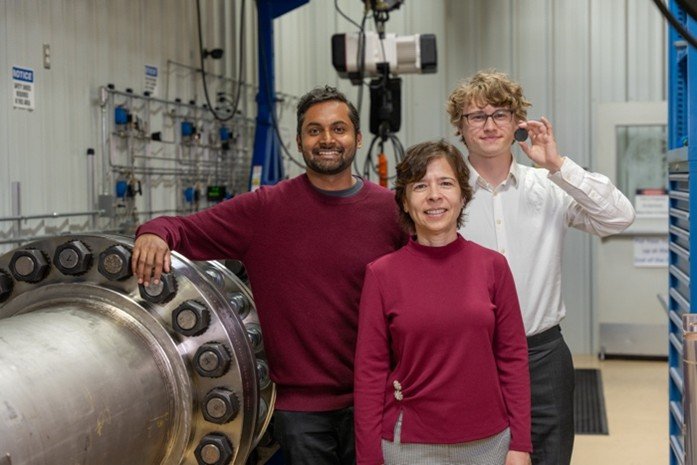 Three people standing in a lab.