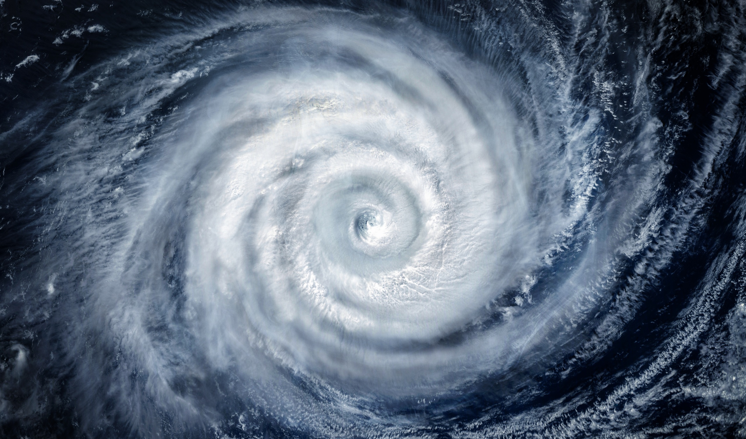 A photo of a hurricane over the ocean taken from a satellite image.