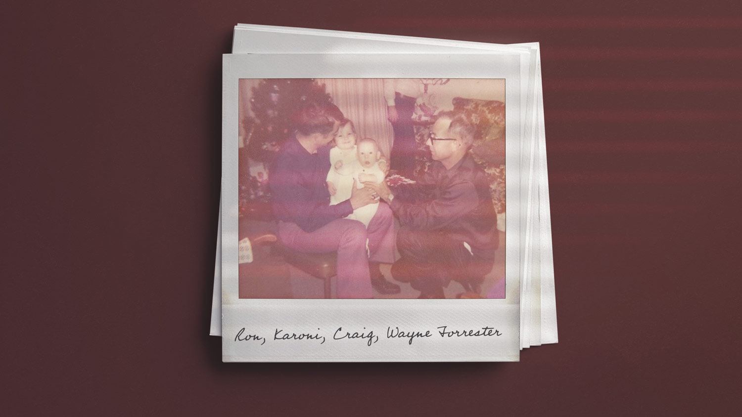 Historic polaroid photo of Ron Forrester holding his baby daughter Karoni and nephew Craig on his lap, with his father Wayn Forrester helping hold the babies