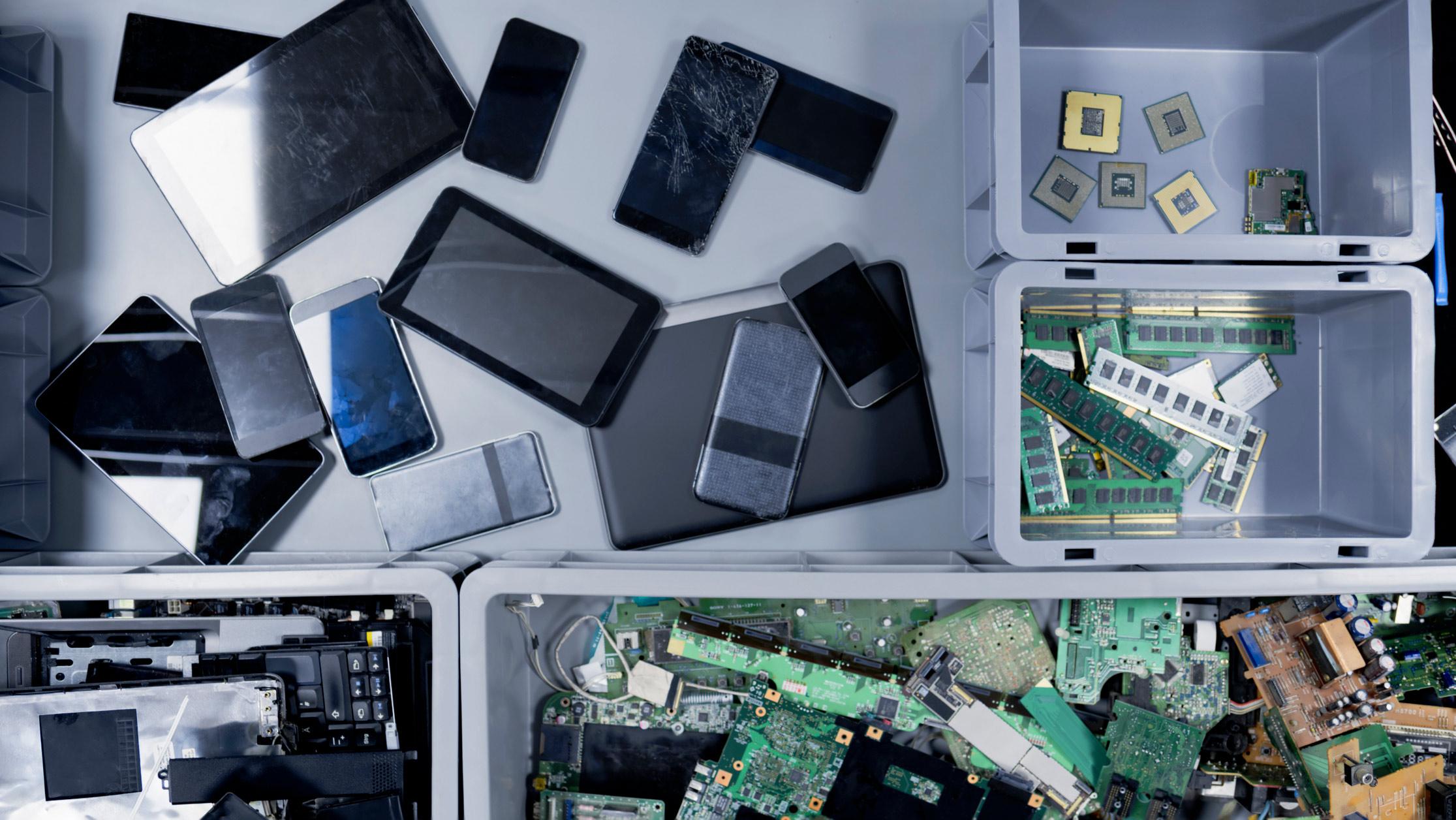 different cell phone parts in bins