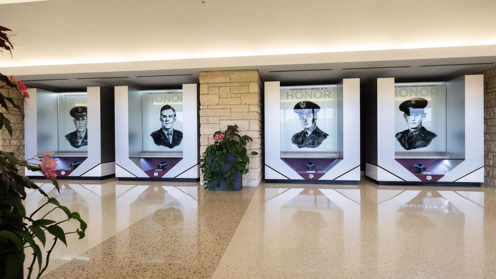 Four illustrations of Aggies awarded the prestigious Medal of Honor displayed in the Hall of Honor