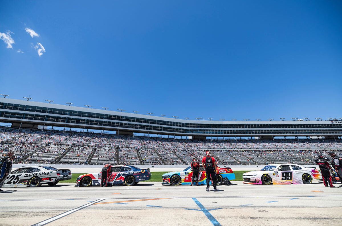 Race cars line up on a track prior to the race