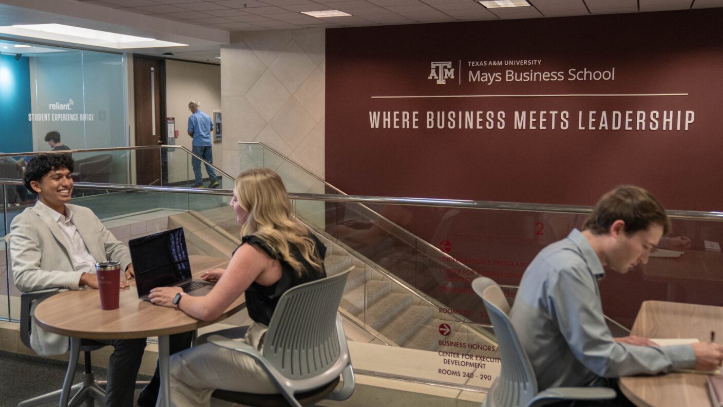 Students work at desks at Mays Business School